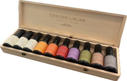 Set of Gregor Lisjak nail polish bottles in a wooden box on a white background